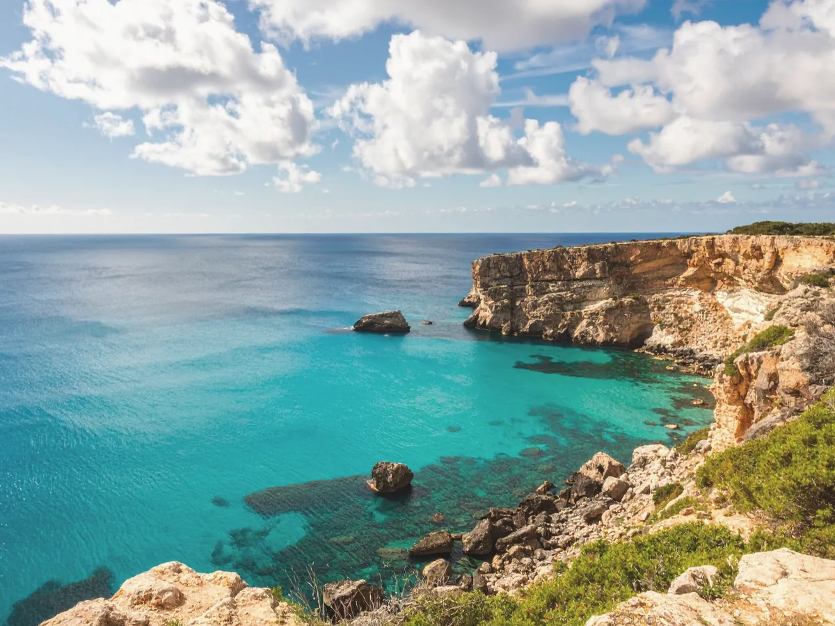 Rock cave opening overlooking the sea at sunset in Cyprus